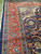 Detail of red border arabesque scrollwork with sky blue rosettes and ivory outlines