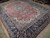 Angled floor view highlighting indigo border with willow tree motifs and rose red central field
