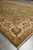 Perspective shot of the vegetable dyed area rug corner with fringe and cream floral border