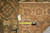 Back tag B-74094 and tape measure beside the ivory border of this Chobi wool rug