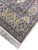 Ivory border corner with blue geometric star medallions, rosette panels and clean cotton fringe