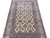 5'2" x 8'7" wool and silk Nain rug shown lengthwise with burgundy medallions on cream field