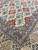 5'2" x 8'7" Nain rug corner showing field meeting layered guard borders and main border