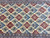 5x9 Persian Nain rug field detail with repeating floral lattice between narrow blue guard stripes