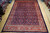 9'2" x 12'10" Persian Mahal rug displayed flat on light wood warehouse showroom floor
