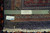 Back of hand-knotted wool rug with ruler, Authentic Handmade tag and cotton fringe visible