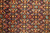 Close-up of Herati fish pattern with turquoise rosettes, ivory leaves and diamond lattice on navy
