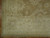 Corner detail showing ivory guard border, rust outlined rosettes and clean woven selvage edge