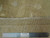 Reverse side with ruler showing hand-knotted wool weave, cotton foundation and authenticity label
