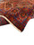 Rug corner turned over to reveal knot density, fringe and the purple main border