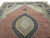 5'2" x 8' Indian Mahi Tabriz rug photographed at an angle, silk highlights catching light