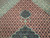 Copper field close-up with cream rosettes, diamond lattice and navy pendant above the medallion