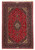 Full view of 4'8" x 7'6" Persian Kashan rug with red field and navy floral border