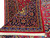 Corner turned back showing navy main border, blue guard bands and hand-woven ivory fringe