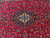 Central medallion of 5x8 Persian Kashan rug with all-over floral red field