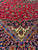 5x8 Persian Kashan rug detail where red field meets the navy main border