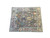 Angled studio photograph showing the whole gray wool Oushak rug and its light blue main border