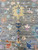 Center field detail showing cream, navy and rose flower heads around the yellow palmette motif