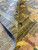 Rolled pile close-up showing natural wool texture, knot density and soft saffron and pink motifs