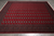8' x 9'2" Pakistani Bokhara rug seen from above, deep red field framed by banded borders