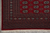 Corner detail of the multi-band border, diamond lattice guard stripe and hand-tied ivory cotton fringe