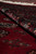 Rolled edge revealing plush pile depth, soft natural wool handle and saturated red ground color