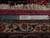 Back of 10x13 Persian rug beside ruler showing tight hand-knotted wool weave and fringe