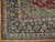 Corner detail showing green spandrel, ivory guard stripe and floral main border of this 8x11 rug