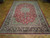 8'4 x 11'1 Isfahan Persian rug angled on parquet, ivory guard borders framing crimson field