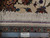 Ruler against Tabriz rug edge confirming fine knot count, authentic hand-knotted label and cotton selvage