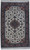 Ivory field Persian Tabriz rug with mauve medallion, camel border and green guard stripes, full view