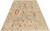 7'11" x 9'11" Oushak area rug photographed at an angle showing soft greige field and ivory border