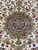 Round medallion framed by ivory field flowers, olive palmettes and muted blue blossoms in wool