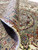 Folded pile corner revealing wool and silk texture, knot density and the ivory cotton foundation