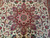 Close-up of the rose red central medallion with teal rosette core and fine wool pile