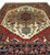 Close view of 9x12 hand-knotted rug medallion, wine red core and denim blue accents