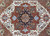 Detail of the central rosette in navy, gold and powder blue on a rust ground