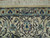 Woven signature cartouche in the top border of this signed Persian Nain wool and silk rug