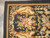 Corner detail of caramel guard stripes, ivory acanthus cartouche and a pink rose spray