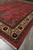 Perspective view of the 7'2" x 10'7" Sarouk rug showing border proportion and red field
