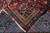 Back of rug folded over front revealing knot density, cotton foundation and crisp design
