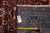 Rug back with dealer tag reading F-4499 and tape measure confirming 10'6" x 17'1" size