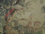 Close-up of red and ivory bird perched above a domed villa in verdure tapestry