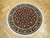 5' x 5'2" round Oriental rug on herringbone parquet floor showing all-over floral field