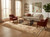 Beige living room styled with ivory Ziegler wool rug, linen sofa and rust leather chairs