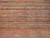 Close-up of handspun wool pile with vegetable dyed stripes in dusty pink, gold and blue tones