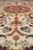 Close-up of pink, blue and sage green floral sprays woven into the ivory silk highlighted pile