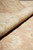 Rolled edge view showing medium pile height and hand knotted construction in natural wool