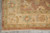 Corner detail of 6' x 9' Ziegler design rug with ivory fringe and floral border