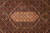 Close-up of ivory hexagonal medallion framed by allover fish pattern in wine red and navy